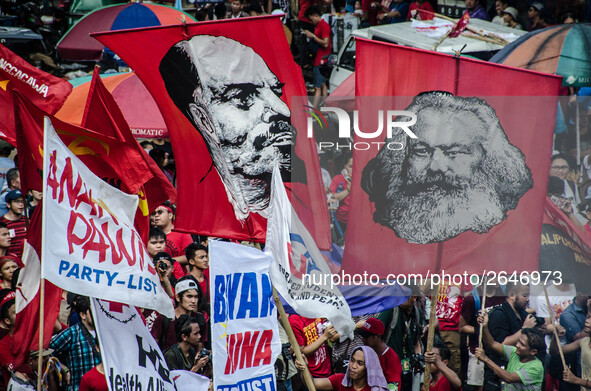 Activists wave images of Karl Marx and Vladimir Lenin during the Labor Day Protest in Mendiola street, Manila, Philippines, on 1st May 2018....