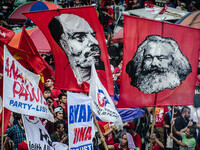 Activists wave images of Karl Marx and Vladimir Lenin during the Labor Day Protest in Mendiola street, Manila, Philippines, on 1st May 2018....