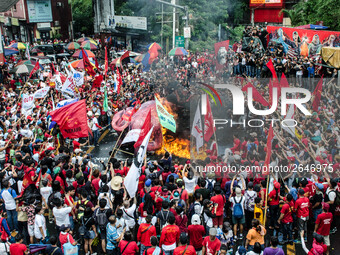 Protesters watch the effigy of President Rodrigo Duterte burn. Thousands of activists attend the Labor Day Protest in Mendiola street, Manil...