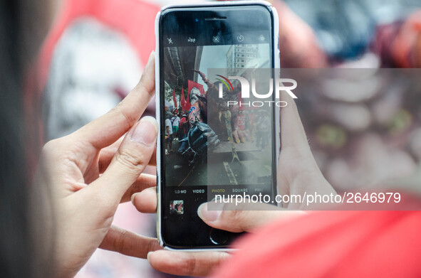 A protester photographs an effigy of President Rodrigo Duterte. For the 2018 Labor Day Protest, the makers of the effigy portrayed President...