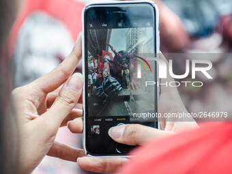 A protester photographs an effigy of President Rodrigo Duterte. For the 2018 Labor Day Protest, the makers of the effigy portrayed President...