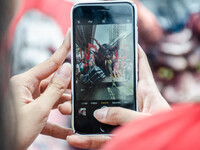 A protester photographs an effigy of President Rodrigo Duterte. For the 2018 Labor Day Protest, the makers of the effigy portrayed President...