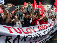 Activists hold a banner and a chain as they urge the President Duterte end contractualization during the Labor Day protest in Mendiola stree...