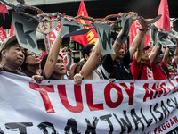 Activists hold a banner and a chain as they urge the President Duterte end contractualization during the Labor Day protest in Mendiola stree...