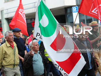 Man with a flag of the Italian governing party Partito Democratico (PD). Several thousands followed the invitation of the trade unions such...