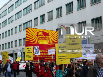 ommunists with a huge banner. Several thousands followed the invitation of the trade unions such as IG Metall, Verdi, GEW and others to prot...