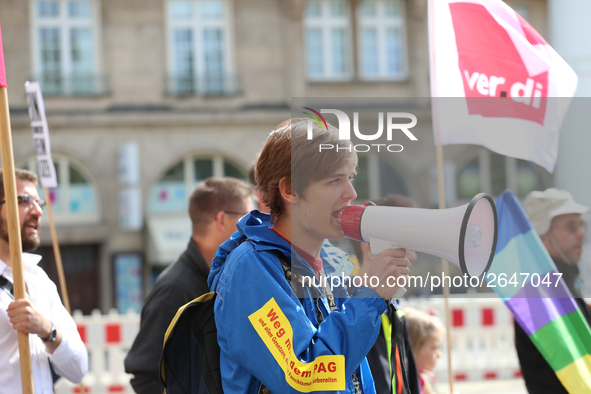 An activist with a bullhorn. Several thousands followed the invitation of the trade unions such as IG Metall, Verdi, GEW and others to prote...