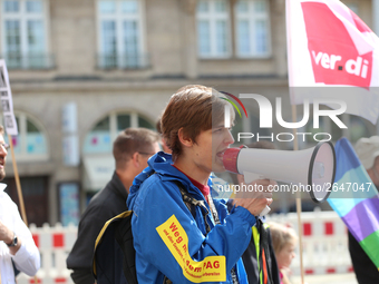 An activist with a bullhorn. Several thousands followed the invitation of the trade unions such as IG Metall, Verdi, GEW and others to prote...