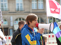 An activist with a bullhorn. Several thousands followed the invitation of the trade unions such as IG Metall, Verdi, GEW and others to prote...