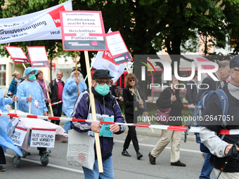 A man protests against the working situation in the hospitals. Several thousands followed the invitation of the trade unions such as IG Meta...