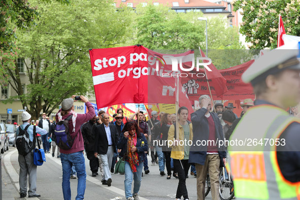 Protestors carry banners against the new Poliziaufgabengesetz of the CSU party as a policeman looks at them. Several thousands followed the...