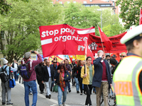 Protestors carry banners against the new Poliziaufgabengesetz of the CSU party as a policeman looks at them. Several thousands followed the...