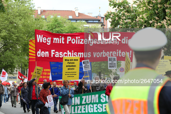 Protestors carry banners against the new Poliziaufgabengesetz of the CSU party as a policeman looks at them. Several thousands followed the...