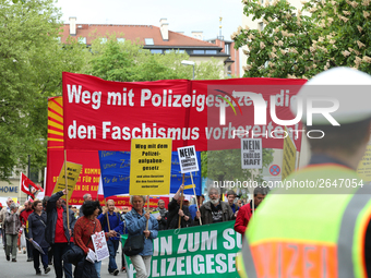 Protestors carry banners against the new Poliziaufgabengesetz of the CSU party as a policeman looks at them. Several thousands followed the...