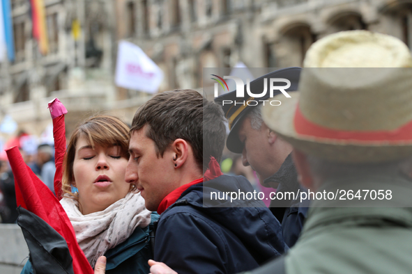 An angry policeman aggresively pushes some activists away. Several thousands followed the invitation of the trade unions such as IG Metall,...