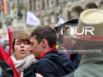 An angry policeman aggresively pushes some activists away. Several thousands followed the invitation of the trade unions such as IG Metall,...