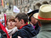 An angry policeman aggresively pushes some activists away. Several thousands followed the invitation of the trade unions such as IG Metall,...