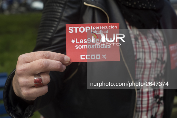 A woman shows a sticker of the union Comisiones Obreras (ccoo) that calls for a stop to the union's persecution during the demonstration on...