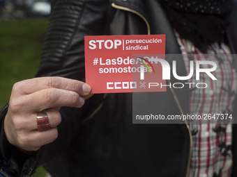 A woman shows a sticker of the union Comisiones Obreras (ccoo) that calls for a stop to the union's persecution during the demonstration on...