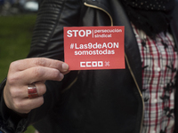 A woman shows a sticker of the union Comisiones Obreras (ccoo) that calls for a stop to the union's persecution during the demonstration on...