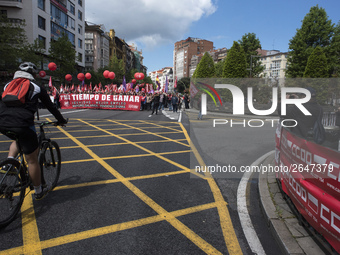 A cyclist passes in front of the demonstration to celebrate the international day of work called by the unions and that runs through the str...