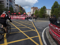 A cyclist passes in front of the demonstration to celebrate the international day of work called by the unions and that runs through the str...