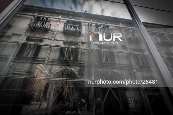 INGV (Istituto Nazionale di Geofisica e Vulcanologia) Palace in the historic center of L'Aquila  reflects a damaged building. 