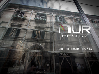 INGV (Istituto Nazionale di Geofisica e Vulcanologia) Palace in the historic center of L'Aquila  reflects a damaged building. (