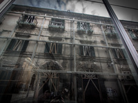 INGV (Istituto Nazionale di Geofisica e Vulcanologia) Palace in the historic center of L'Aquila  reflects a damaged building. (