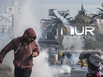 Demonstrators clash with riot police following a May Day march in Santiago on May 1, 2018.  The clashes between demonstrators and carabinero...