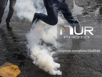 Demonstrators clash with riot police following a May Day march in Santiago on May 1, 2018.  The clashes between demonstrators and carabinero...