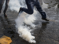 Demonstrators clash with riot police following a May Day march in Santiago on May 1, 2018.  The clashes between demonstrators and carabinero...