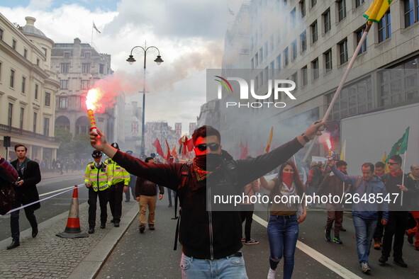 Kurdish protesters set off Flares at Mayday . International Workers Day in London kicked off with a march through Central London and ended i...