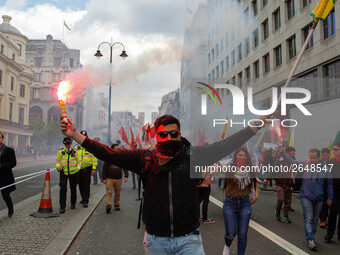 Kurdish protesters set off Flares at Mayday . International Workers Day in London kicked off with a march through Central London and ended i...