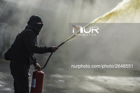 Demonstrators clash with riot police following a May Day march in Santiago on May 1, 2018. The clashes between demonstrators and carabineros...