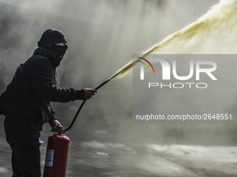 Demonstrators clash with riot police following a May Day march in Santiago on May 1, 2018. The clashes between demonstrators and carabineros...