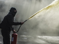 Demonstrators clash with riot police following a May Day march in Santiago on May 1, 2018. The clashes between demonstrators and carabineros...