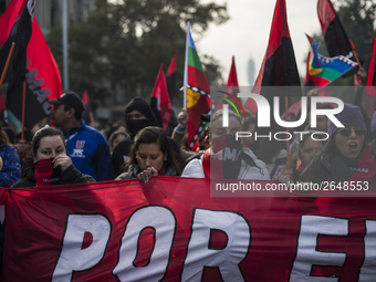 Demonstrators clash with riot police following a May Day march in Santiago on May 1, 2018.  The clashes between demonstrators and carabinero...