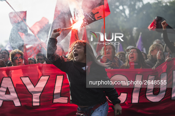 Demonstrators clash with riot police following a May Day march in Santiago on May 1, 2018. The clashes between demonstrators and carabineros...