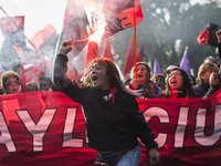 Demonstrators clash with riot police following a May Day march in Santiago on May 1, 2018. The clashes between demonstrators and carabineros...