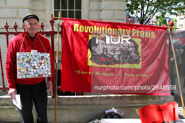 Protester with Communist flag at Mayday . International Workers Day in London kicked off with a march through Central London and ended in Tr...