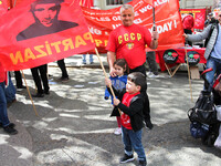 Child with Partizan Flag . International Workers Day in London kicked off with a march through Central London and ended in Trafalgar Square...