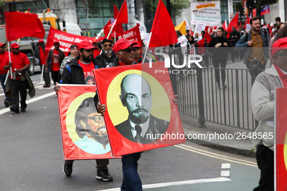 Mayday Marcher carries Image of Lenin . International Workers Day in London kicked off with a march through Central London and ended in Traf...