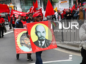 Mayday Marcher carries Image of Lenin . International Workers Day in London kicked off with a march through Central London and ended in Traf...