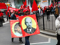 Mayday Marcher carries Image of Lenin . International Workers Day in London kicked off with a march through Central London and ended in Traf...