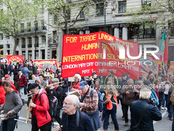 Mayday Marchers head through the Strand . International Workers Day in London kicked off with a march through Central London and ended in Tr...