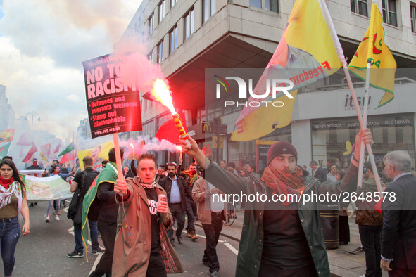 Kurdish protesters set off Flares at Mayday . International Workers Day in London kicked off with a march through Central London and ended i...