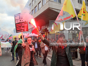 Kurdish protesters set off Flares at Mayday . International Workers Day in London kicked off with a march through Central London and ended i...