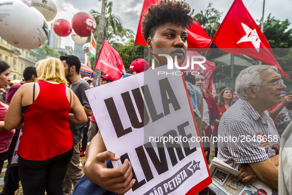 Supporters of the Workers' Party founder and Brazilian ex-president (2003-2011) Luiz Inacio Lula da Silva take part in a May Day rally at Re...