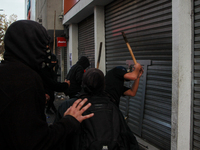 Demonstrators clash with riot police following a May Day march in Santiago on May 1, 2018. ( (